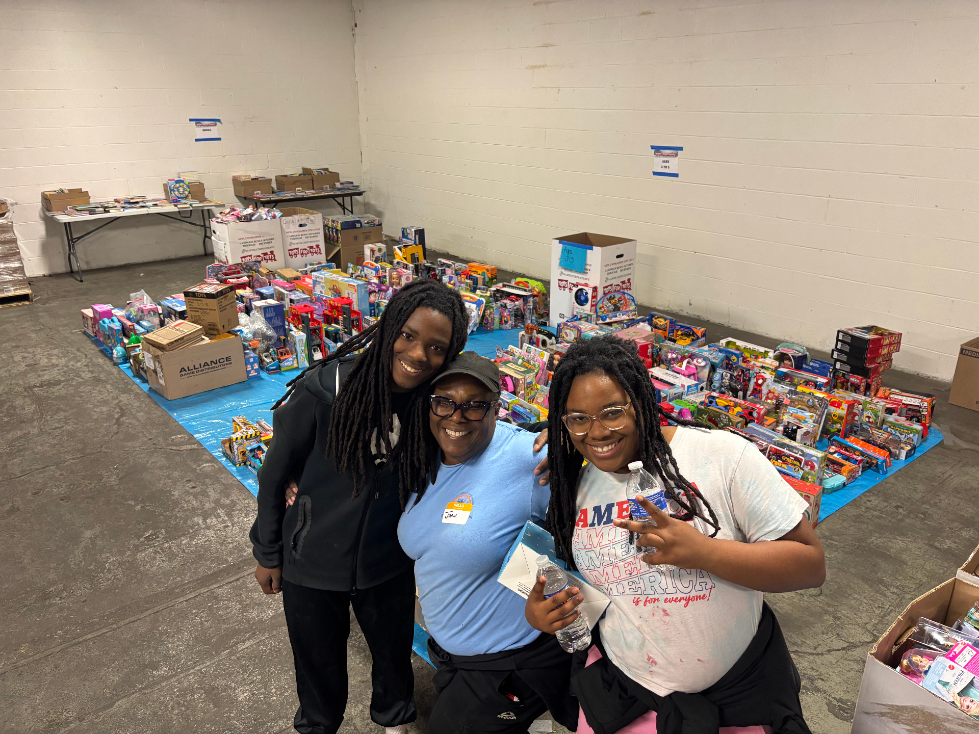 Kingdom Changers volunteers smiling at a community toy giveaway