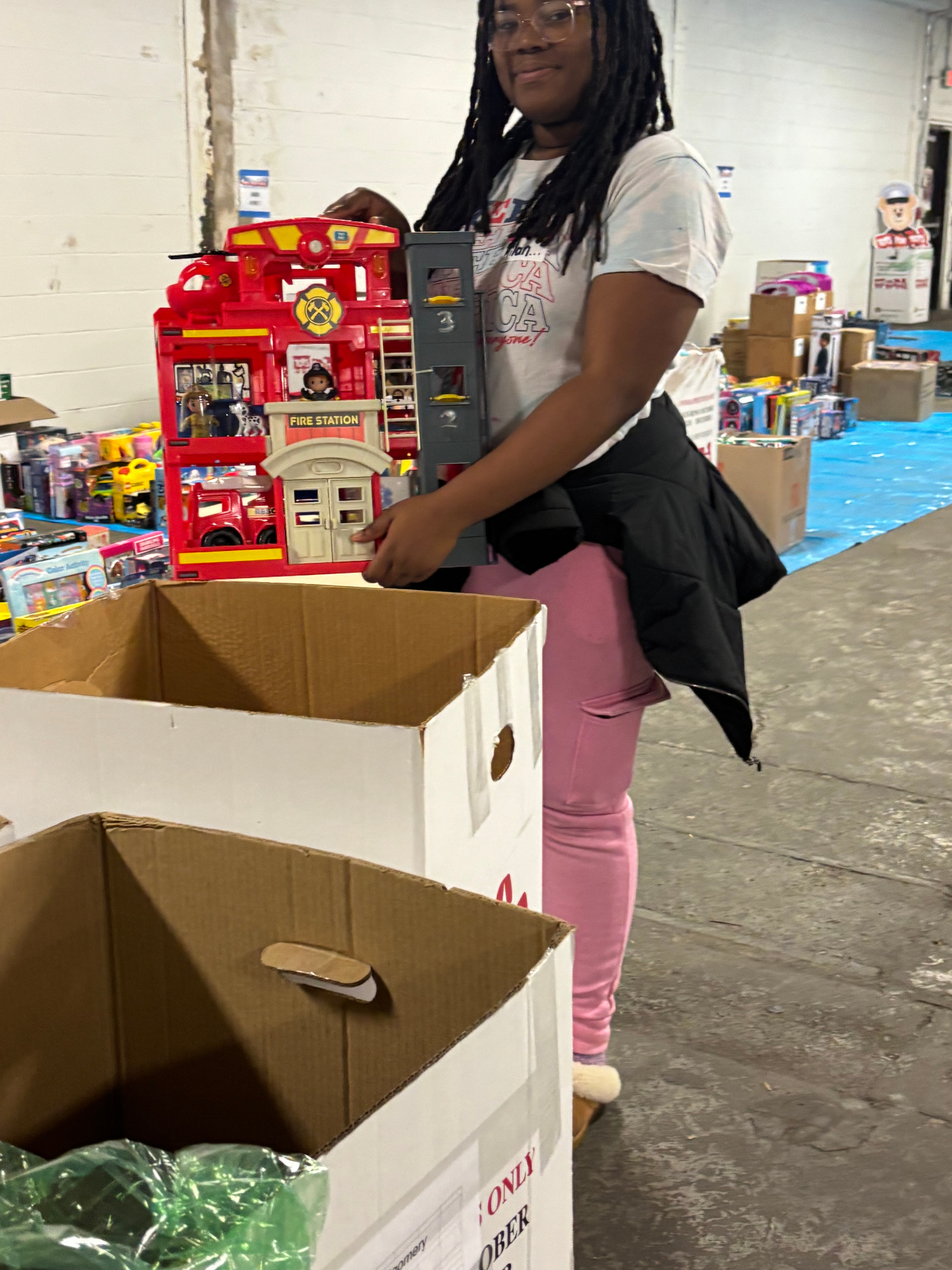 Kingdom Changers volunteer holding a toy fire station